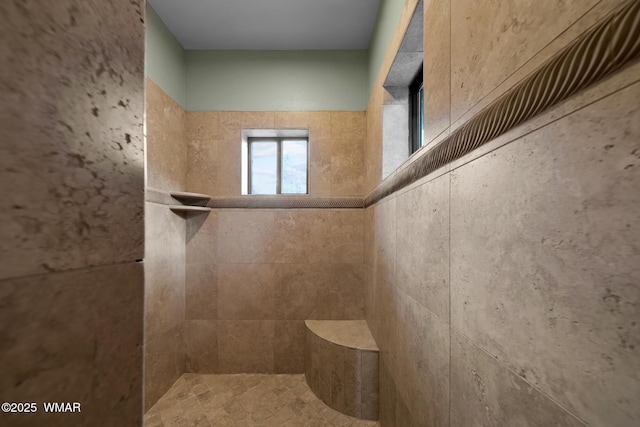 bathroom with a tile shower