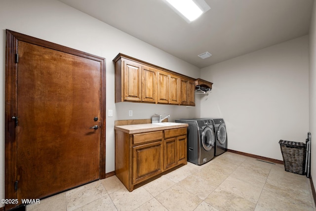 laundry room with cabinet space, visible vents, baseboards, and separate washer and dryer