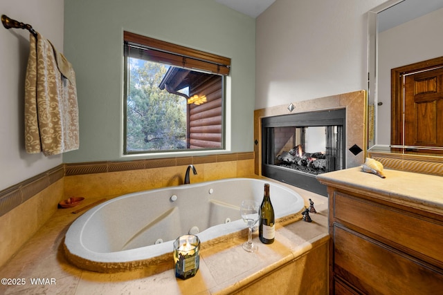 bathroom featuring a whirlpool tub and a multi sided fireplace