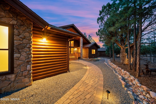 view of side of home featuring stone siding