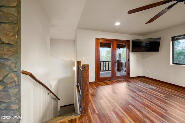 interior space featuring french doors, ceiling fan, baseboards, and wood finished floors