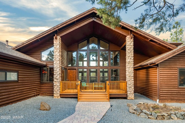 doorway to property with log veneer siding