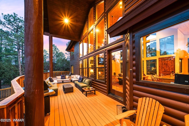 deck at dusk featuring outdoor lounge area