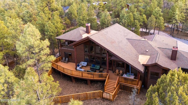 birds eye view of property featuring a view of trees