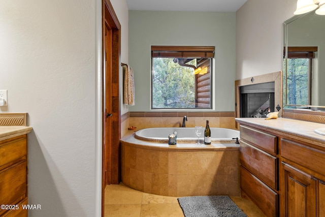 bathroom with a bath, a fireplace, and vanity