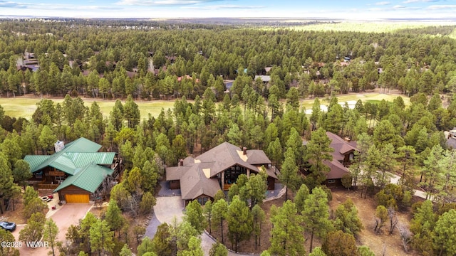 birds eye view of property with a wooded view