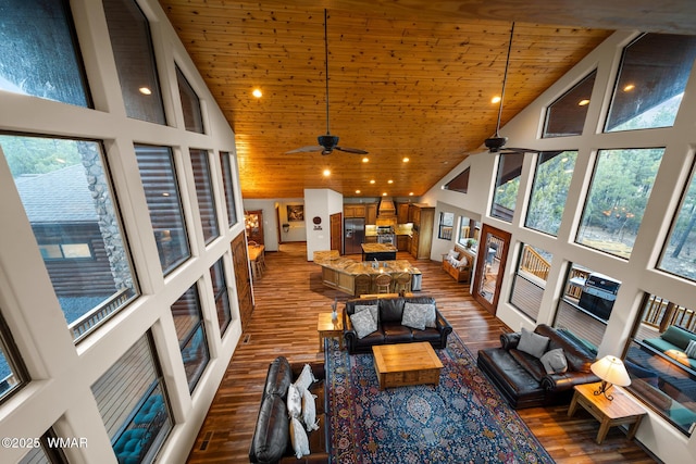 living room with high vaulted ceiling, dark wood finished floors, and wood ceiling