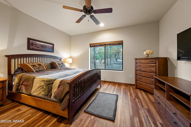 bedroom with a ceiling fan, recessed lighting, baseboards, and wood finished floors