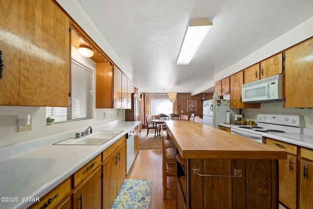 2681 W Reidhead, Show Low, AZ 85901 - kitchen featuring white appliances, butcher block counters, light wood-style flooring, a kitchen island, and brown cabinetry