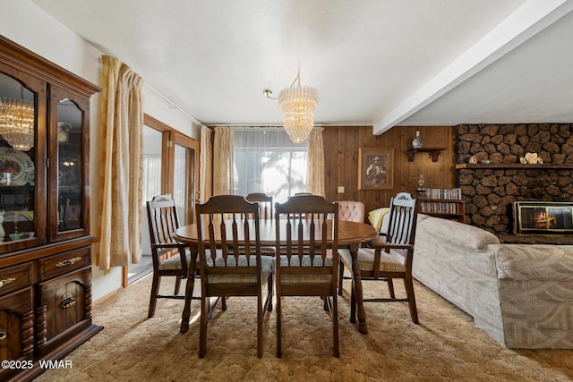 2681 W Reidhead, Show Low, AZ 85901 - carpeted dining area featuring beam ceiling, a chandelier, a stone fireplace, and wooden walls