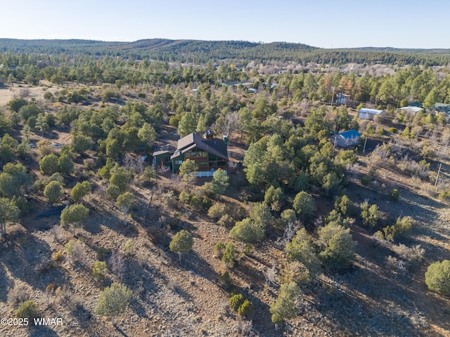 birds eye view of property with a view of trees