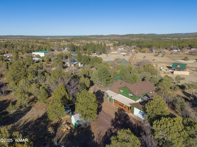 bird's eye view featuring a wooded view