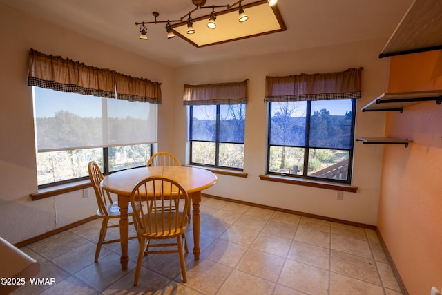 dining room featuring light tile patterned floors and baseboards