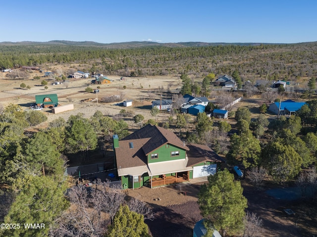 bird's eye view featuring a wooded view and a mountain view