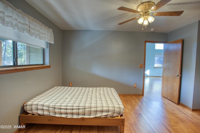 bedroom with baseboards and wood finished floors