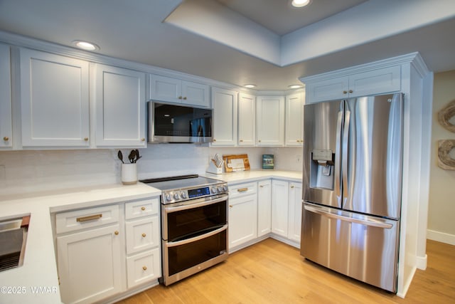 3651 Crown Dancer Dr Unit 8, Pinetop, AZ 85935 - kitchen with white cabinetry, light countertops, stainless steel appliances, and light wood-type flooring