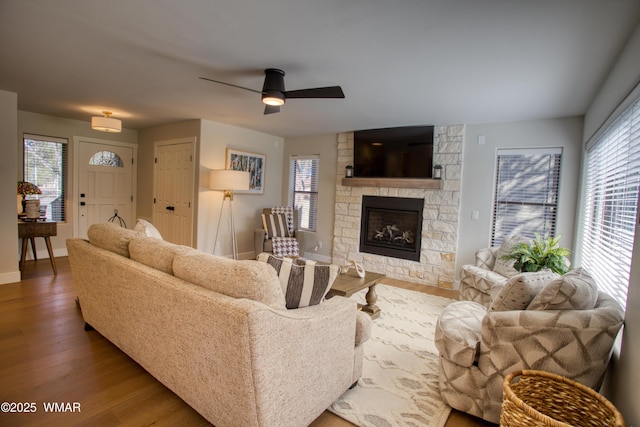 3651 Crown Dancer Dr Unit 8, Pinetop, AZ 85935 - living area with a stone fireplace, a healthy amount of sunlight, and wood finished floors