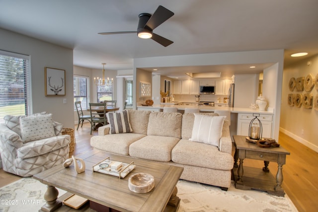 3651 Crown Dancer Dr Unit 8, Pinetop, AZ 85935 - living room featuring ceiling fan with notable chandelier, baseboards, light wood finished floors, and recessed lighting
