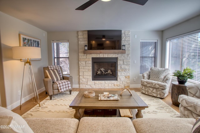 3651 Crown Dancer Dr Unit 8, Pinetop, AZ 85935 - living room with baseboards, ceiling fan, wood finished floors, and a stone fireplace