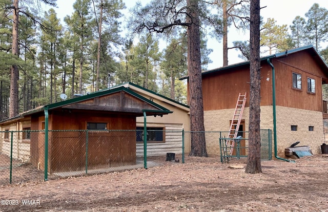 view of side of home featuring fence