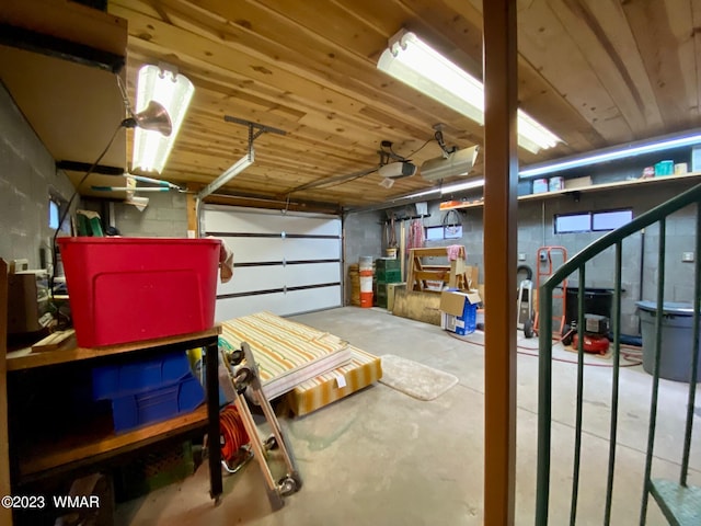 garage featuring wood ceiling and a garage door opener