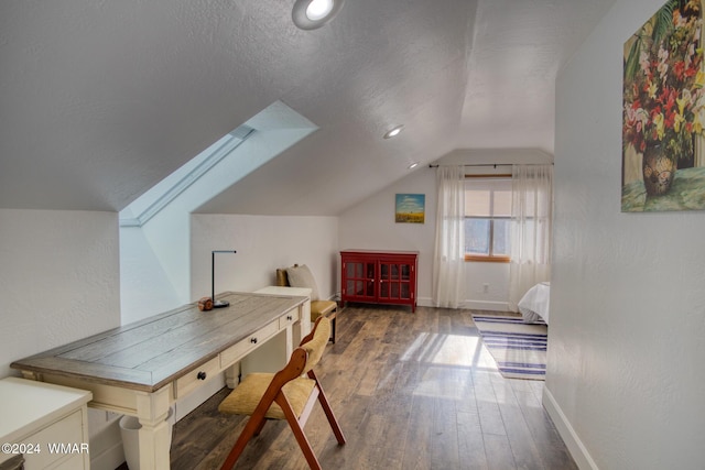 interior space featuring dark wood-style floors, vaulted ceiling, a textured ceiling, and baseboards