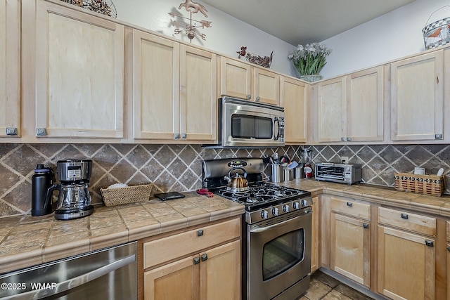 4509 Stone Pine Dr, Pinetop, AZ 85935 - kitchen with appliances with stainless steel finishes, light brown cabinetry, and tasteful backsplash
