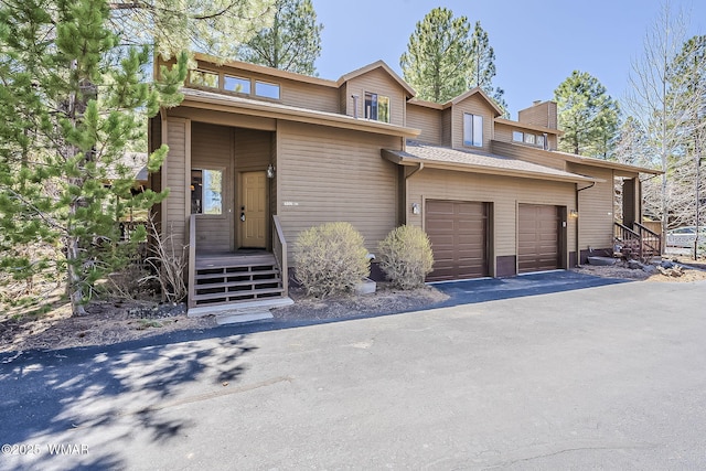 4509 Stone Pine Dr, Pinetop, AZ 85935 - view of front of property featuring a chimney, an attached garage, and asphalt driveway