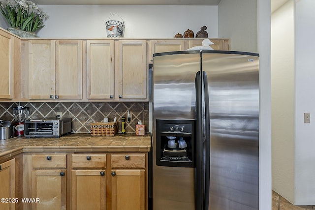 4509 Stone Pine Dr, Pinetop, AZ 85935 - kitchen featuring stainless steel fridge with ice dispenser, decorative backsplash, tile counters, and light brown cabinetry