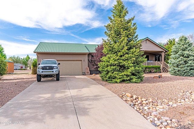 7046 Dusty Saddle Trl, Show Low, AZ 85901 - obstructed view of property with concrete driveway, metal roof, and a garage