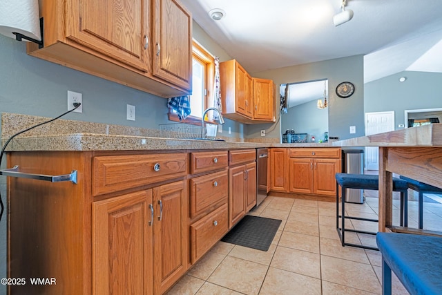 7046 Dusty Saddle Trl, Show Low, AZ 85901 - kitchen with tile countertops, stainless steel dishwasher, light tile patterned floors, vaulted ceiling, and brown cabinets