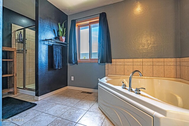 7046 Dusty Saddle Trl, Show Low, AZ 85901 - full bath featuring a garden tub, a textured wall, a stall shower, tile patterned floors, and baseboards