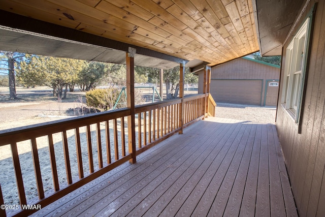 deck featuring an outdoor structure and a detached garage