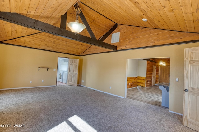 unfurnished room featuring lofted ceiling with beams, wooden ceiling, carpet flooring, baseboards, and washer / clothes dryer