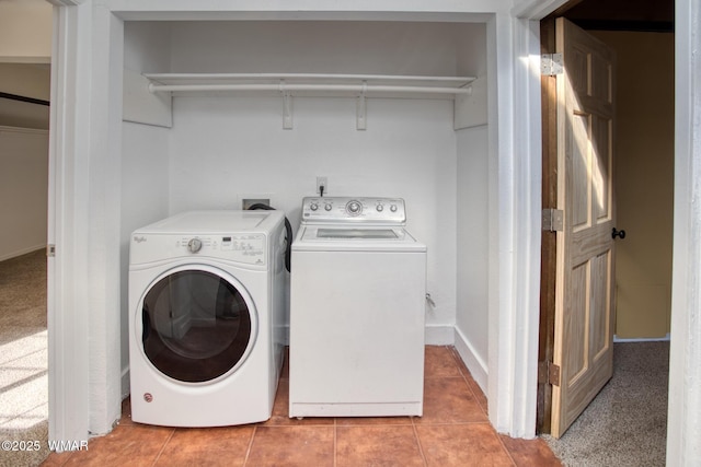 washroom with light tile patterned floors, laundry area, and washer and dryer