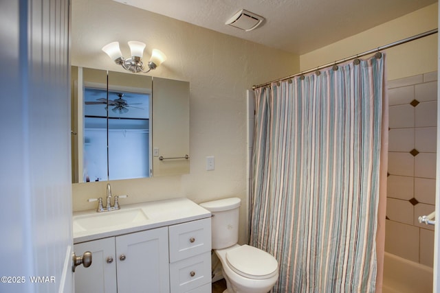 bathroom featuring visible vents, a ceiling fan, a textured wall, toilet, and vanity