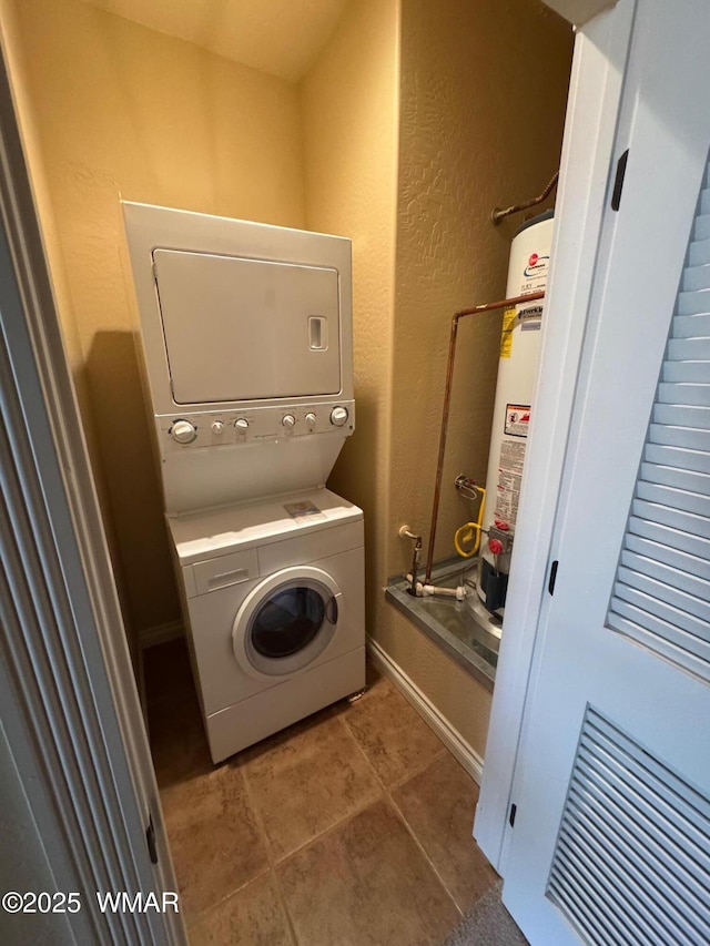 5200 S Morgan Mountain Dr, Show Low, AZ 85901 - laundry area with stacked washer / dryer, water heater, tile patterned flooring, and a textured wall