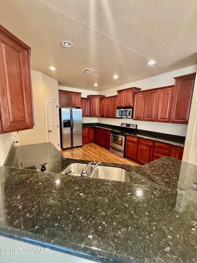 5200 S Morgan Mountain Dr, Show Low, AZ 85901 - kitchen featuring stainless steel appliances, dark stone counters, and recessed lighting