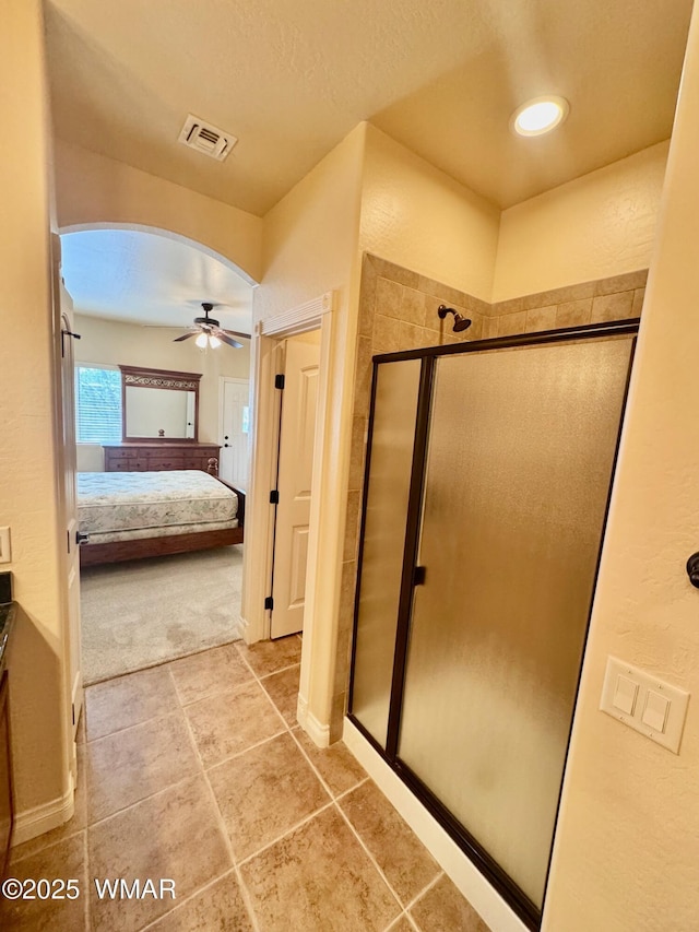 5200 S Morgan Mountain Dr, Show Low, AZ 85901 - ensuite bathroom with ceiling fan, a stall shower, tile patterned floors, and vanity