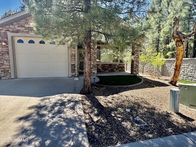 5200 S Morgan Mountain Dr, Show Low, AZ 85901 - view of property hidden behind natural elements with stone siding, concrete driveway, and a garage