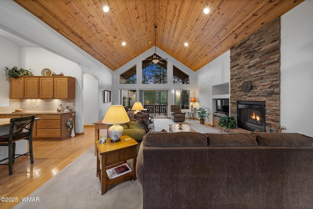 20 W Suncrest Ct, Show Low, AZ 85901 - living room with a ceiling fan, arched walkways, a fireplace, high vaulted ceiling, and light wood-style floors