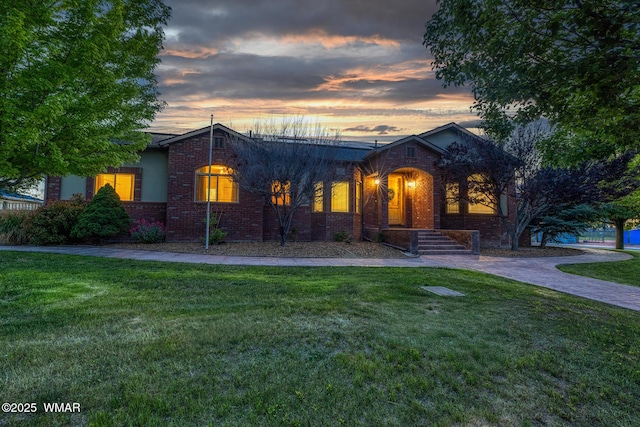 416 S 2nd St, Snowflake, AZ 85937 - view of front of home with brick siding and a yard