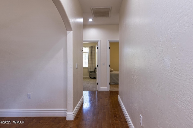 416 S 2nd St, Snowflake, AZ 85937 - hallway with arched walkways, baseboards, dark wood-type flooring, and a textured wall