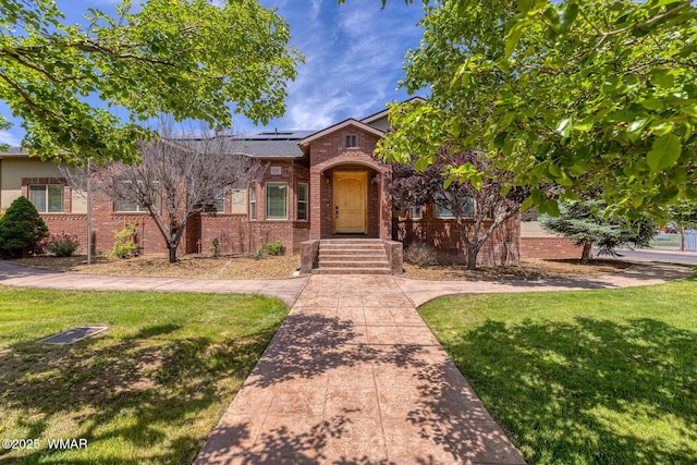 416 S 2nd St, Snowflake, AZ 85937 - view of front of home with brick siding, solar panels, and a front lawn