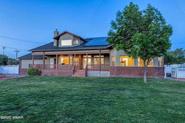 416 S 2nd St, Snowflake, AZ 85937 - view of front facade featuring solar panels, a chimney, brick siding, and a porch