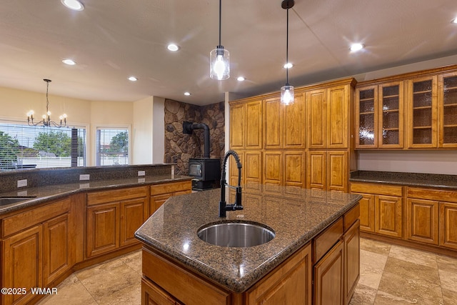 416 S 2nd St, Snowflake, AZ 85937 - kitchen with a sink, a wood stove, brown cabinets, a center island with sink, and recessed lighting