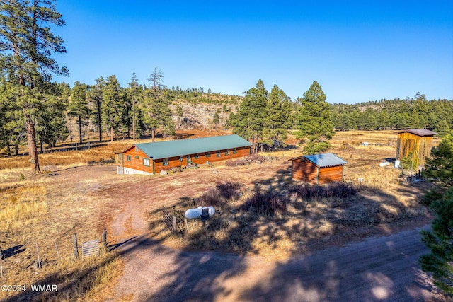 birds eye view of property with a rural view and a view of trees