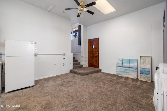 unfurnished room featuring ceiling fan, stairway, and carpet flooring