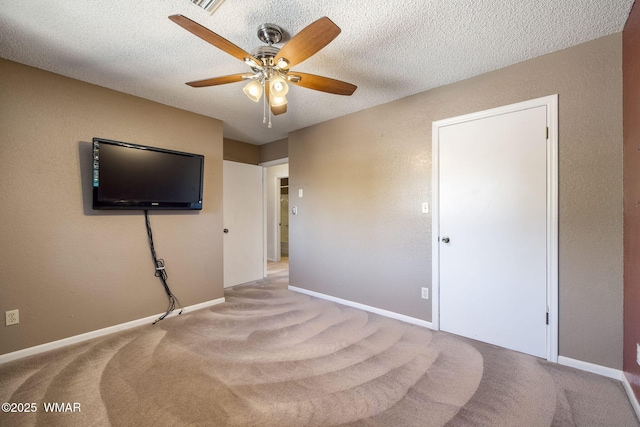 bedroom with a textured ceiling, ceiling fan, light carpet, and baseboards