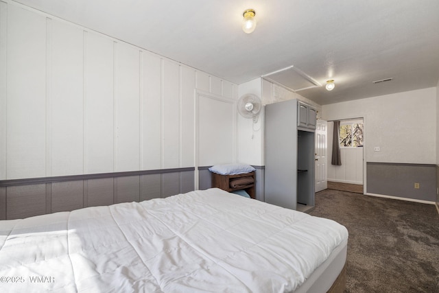 bedroom with visible vents and dark carpet